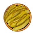 Sliced pickled cucumbers, also known as pickle or gherkin, in wooden bowl