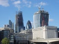 The `Gherkin` between two skyscrapers under construction in the City of London Royalty Free Stock Photo