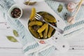 Gherkins, pickled cucumber on a fork, bowl of marinated vegetables Royalty Free Stock Photo