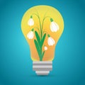 Tungsten light bulb with snowdrops inside Royalty Free Stock Photo