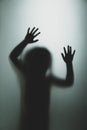 Ghost concept shadow of a child behind the matte glass blurry hand Royalty Free Stock Photo