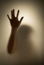 Ghost concept shadow of a woman behind the matte glass blurry hand and body Royalty Free Stock Photo