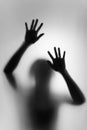 Ghost concept shadow of a woman behind the matte glass blurry hand Royalty Free Stock Photo