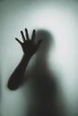Ghost concept shadow of a woman behind the matte glass blurry hand Royalty Free Stock Photo