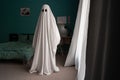 Ghost covered with a white ghost sheet on a bedroom in new house. Halloween