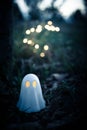 Ghost figurine with lit eyes in outdoor setting, halloween background