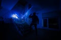 Ghost in Haunted House at stairs, Mysterious silhouette of ghost man with light at stairs, Horror scene of scary ghost spooky llig Royalty Free Stock Photo