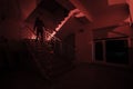 Ghost in Haunted House at stairs, Mysterious silhouette of ghost man with light at stairs, Horror scene of scary ghost spooky llig Royalty Free Stock Photo