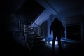 Ghost in Haunted House at stairs, Mysterious silhouette of ghost man with light at stairs, Horror scene of scary ghost spooky llig Royalty Free Stock Photo