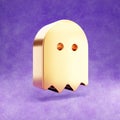 Ghost icon. Gold glossy Ghost symbol isolated on violet velvet background.