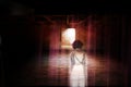 Ghost little girl appears in old dark room, child is confined to death. Royalty Free Stock Photo