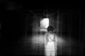 Ghost little girl appears in old dark room, ghost in haunted house, child is confined to death. Royalty Free Stock Photo