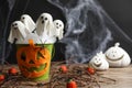 Ghost shaped cake pops on wooden table, space for text. Halloween treat Royalty Free Stock Photo