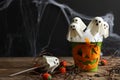 Ghost shaped cake pops on wooden table, space for text. Halloween treat Royalty Free Stock Photo