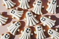 Ghost-shaped halloween cookies with white icing on pastel pink background Royalty Free Stock Photo