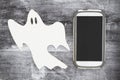 Ghosting someone online message with a white ghost and cell phone Royalty Free Stock Photo