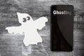 Ghosting someone online message with a white ghost and cell phone Royalty Free Stock Photo