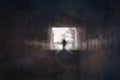 A ghostly blurred figure.at the end of a tunnel. On a spooky country track. With a grunge vintage edit Royalty Free Stock Photo