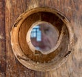 Ghostly face and eye looking through peephole