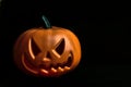 Ghostly isolated plastic Halloween orange pumpkin with scary face