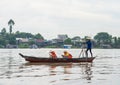 An Giang, Vietnam - Nov 29, 2014: Tourists carried by rowing boat on Tien river, Mekong delta. They enjoying cellphone instead of Royalty Free Stock Photo