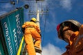 An Giang, Vietnam - Sep 6, 2016: Asian electrician climb high on pole to repair electrical system in Chau Doc district, An Giang p