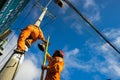 An Giang, Vietnam - Sep 6, 2016: Asian electrician climb high on pole to repair electrical system in Chau Doc district, An Giang p