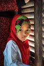 An Giang, Vietnam - Sep 6, 2016: Portrait of Vietnamese muslim little girl wearing traditional red dress in a champa village, Khan Royalty Free Stock Photo