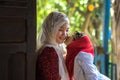 An Giang, Vietnam - Sep 6, 2016: Vietnamese muslim girl wearing traditional red dress playing with her sister in a champa village,