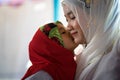 An Giang, Vietnam - Sep 6, 2016: Vietnamese muslim girl wearing traditional red dress playing with her sister in a champa village, Royalty Free Stock Photo