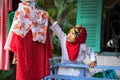 An Giang, Vietnam - Sep 6, 2016: Vietnamese muslim little girl hanging clothes for outdoor drying in a champa village, Khanh Hoan