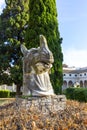 Giant ancient animal head in 16th-century garden, Cloister of Michelangelo at 3rd century Baths of Diocletian, Rome, Italy