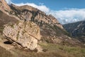 Giant balancing boulder rock. Beautiful mountain landscape with giant granite stone among on hill and mountains. Colorful highland