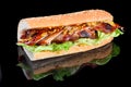 Giant BBQ Rib Sandwich with salad leaf and French mustard in baguette. isolated on a black background Royalty Free Stock Photo