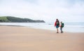 Giant beach of Biskay Bay, North Spain. Mother and son Camino de Royalty Free Stock Photo