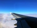 Aeroplane wing over the white cloud sky Royalty Free Stock Photo