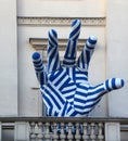 Giant blue hand sculpture on Collegium Nobilium