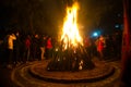 Giant bon fire lit for the festival of Lohri surrounded by people Royalty Free Stock Photo