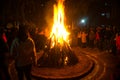 Giant bon fire lit for the festival of Lohri surrounded by people Royalty Free Stock Photo