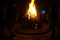 Giant bon fire lit for the festival of Lohri surrounded by people Royalty Free Stock Photo