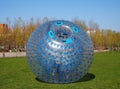 A giant bubble balloon for outdoor inflatable games with a person inside it, zorbing