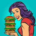 Giant Burger. Hungry woman eating fast food