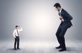 Giant businessman scared of small businessman Royalty Free Stock Photo