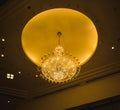 Giant chandelier with glowing yellow circle ceiling same as the moon Royalty Free Stock Photo