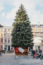 Giant Christmas tree with a gift tag in Covent Garden Market, London, UK.