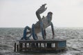 Giant crab statue on top of the wooden dock in the sea