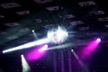 Giant disco mirror ball hanging and glowing under the ceiling