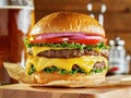 Huge cheeseburger with beer in background Royalty Free Stock Photo