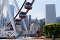 Giant Ferris Wheel next to modern buildings during daytime in Hong Kong