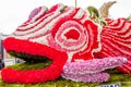 Giant Fish Carnival Float Made of Flowers. Big Statue Covered with Pink and Red Carnations and Roses